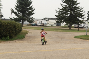 A child biking in Joffre Mobile Home Park